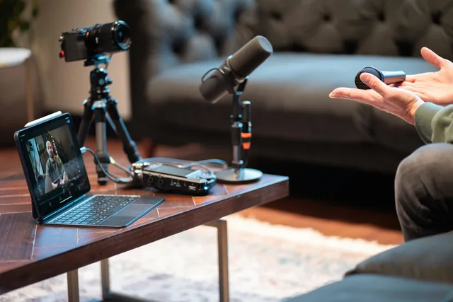 Podcast recording studio with a microphone, camera and computer