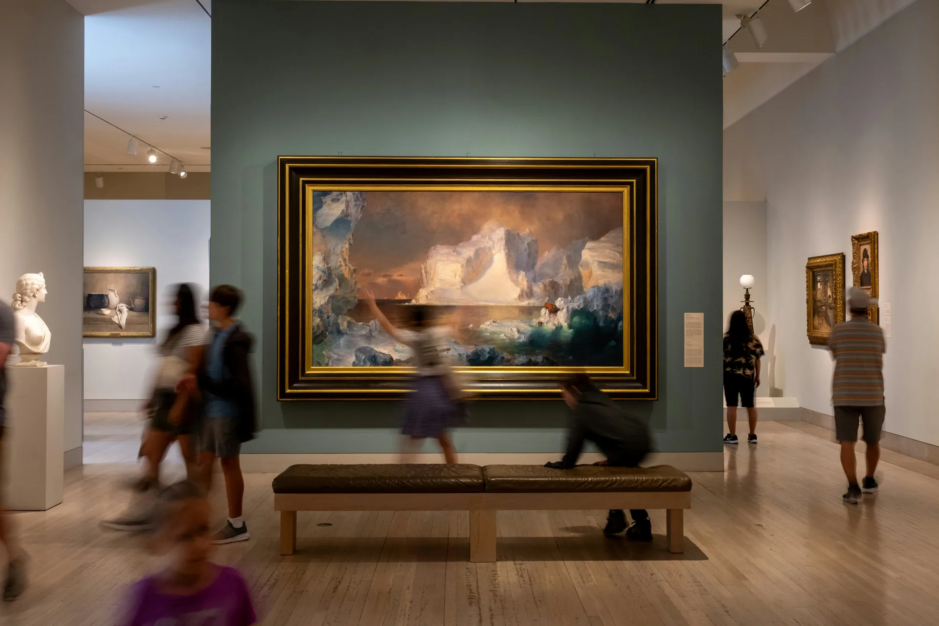 Visitors exploring an exhibition in an art gallery